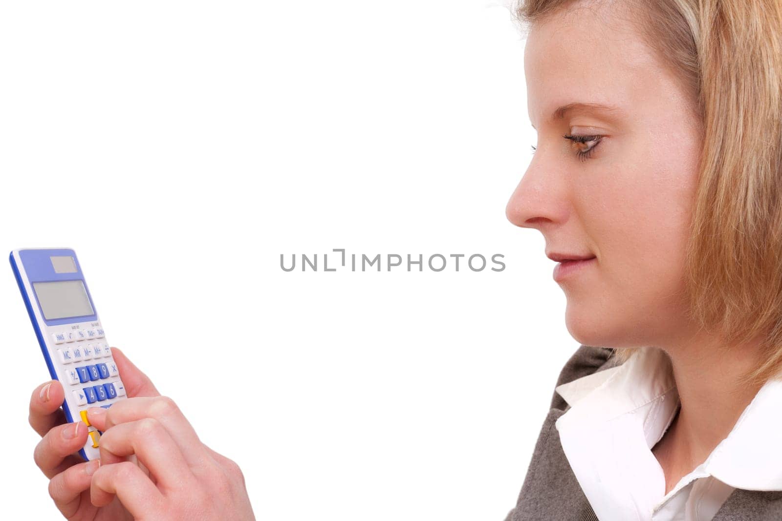 Young woman operating a calculator