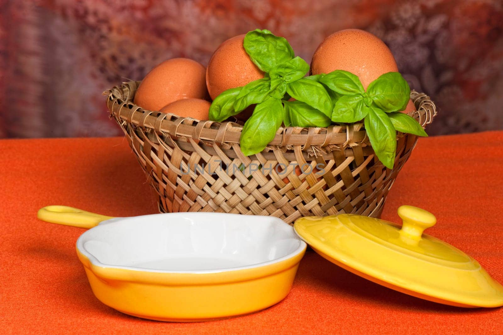 A basket of fresh eggs with orange background