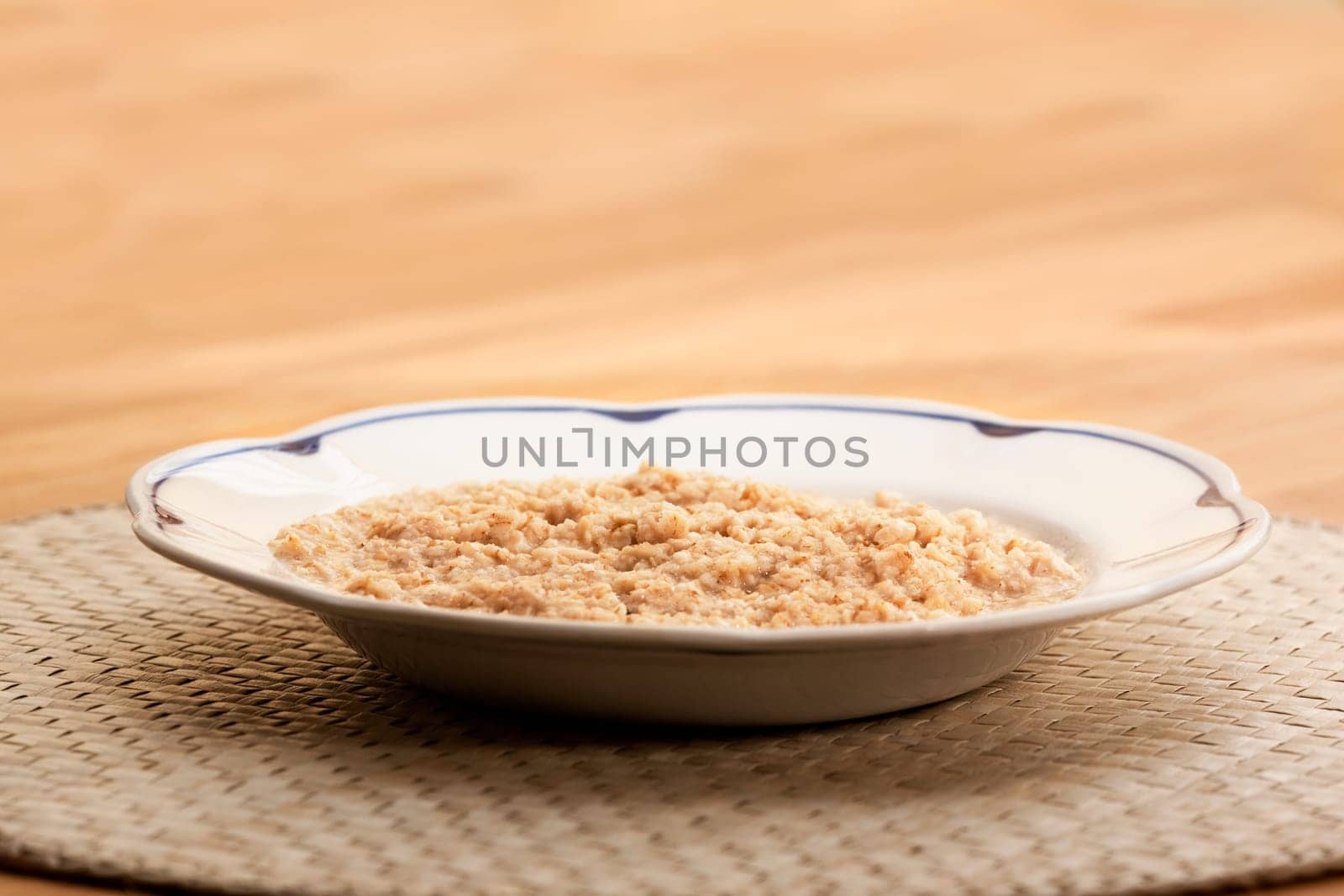 A bowl of porridge on a wooden table.