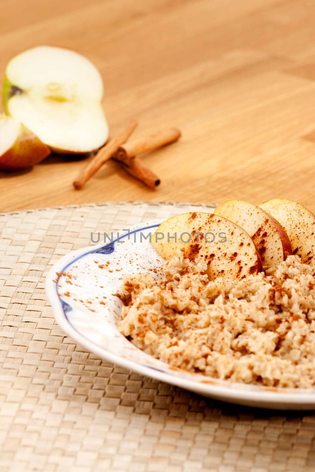 Apple Cinnamon Porridge with fresh ingredients in the background