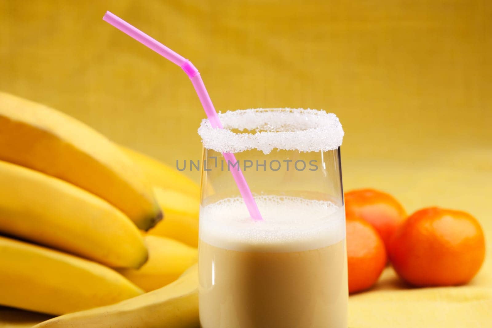 A smoothie made from oranges and bananas in an elegant glass