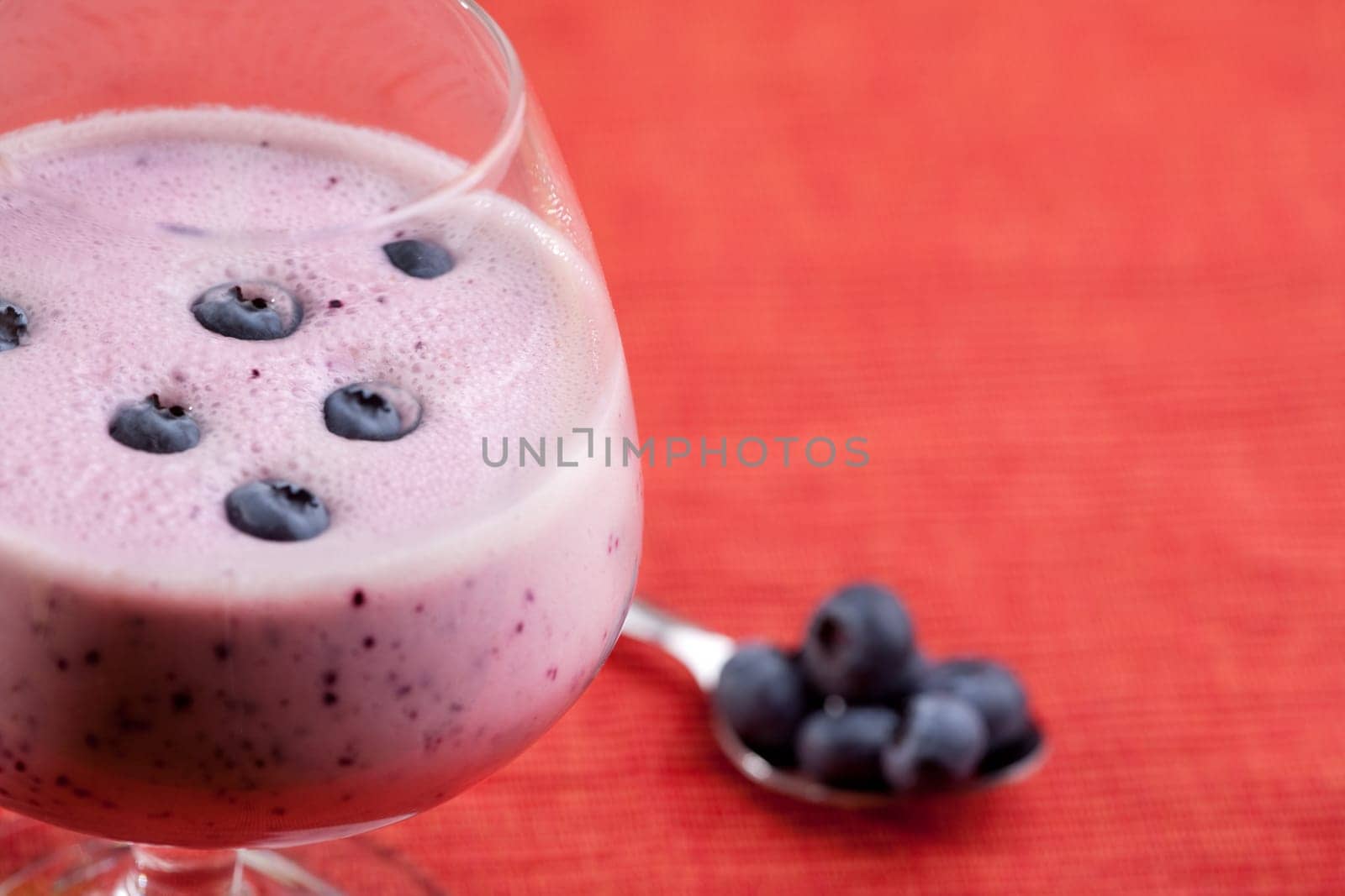 A delicious blueberry smoothie over a red cloth background
