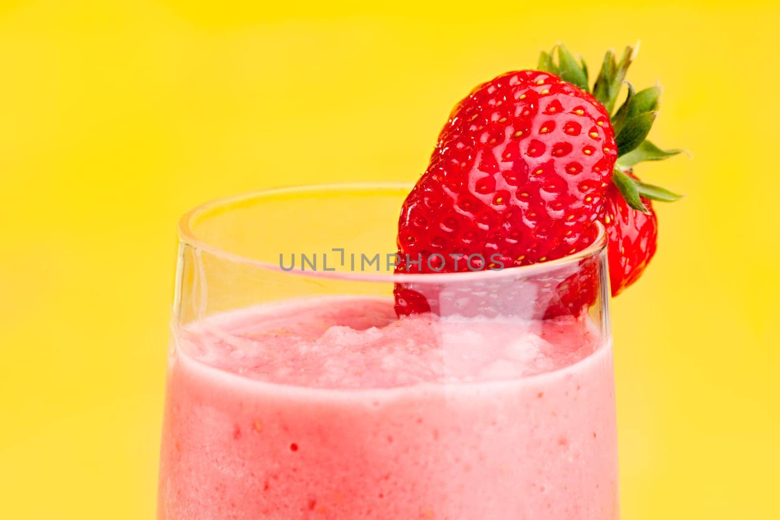 A fresh strawberry smoothie isolated over yellow