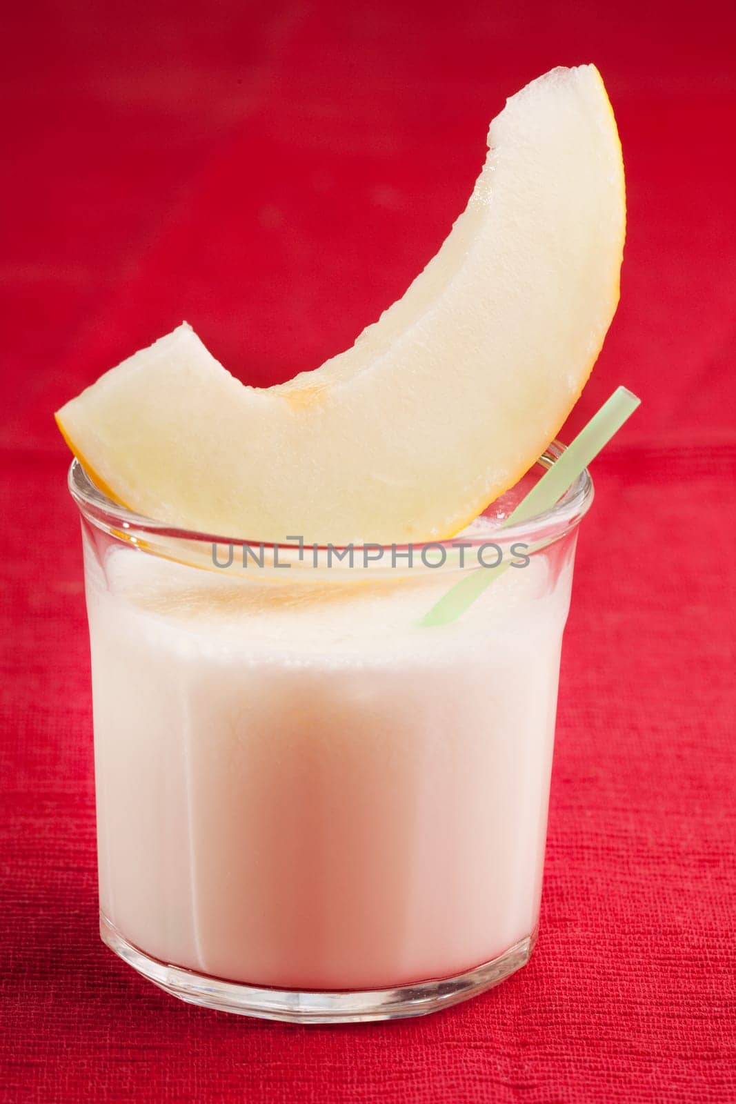 A sweet melon smoothie on a red cloth