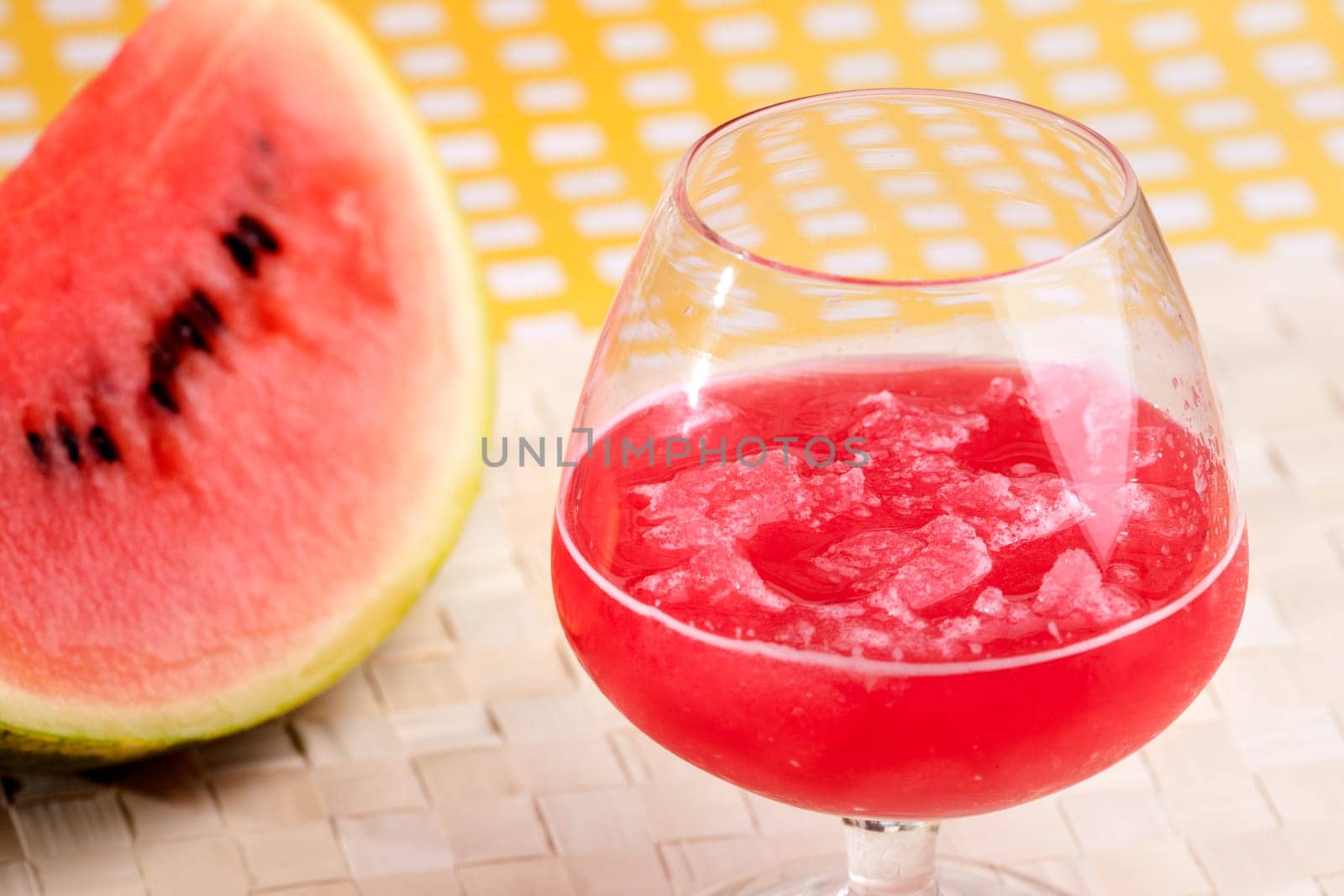 A red watermelon drink on a picnic table