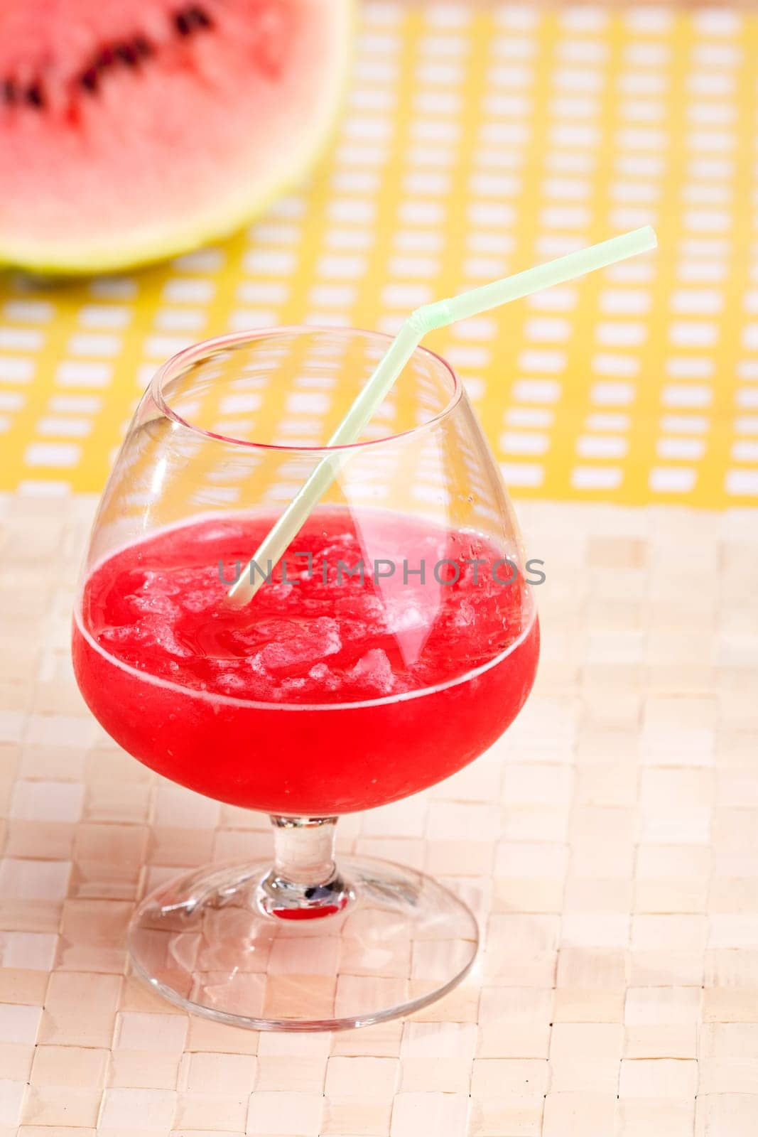 A red watermelon drink on a picnic table