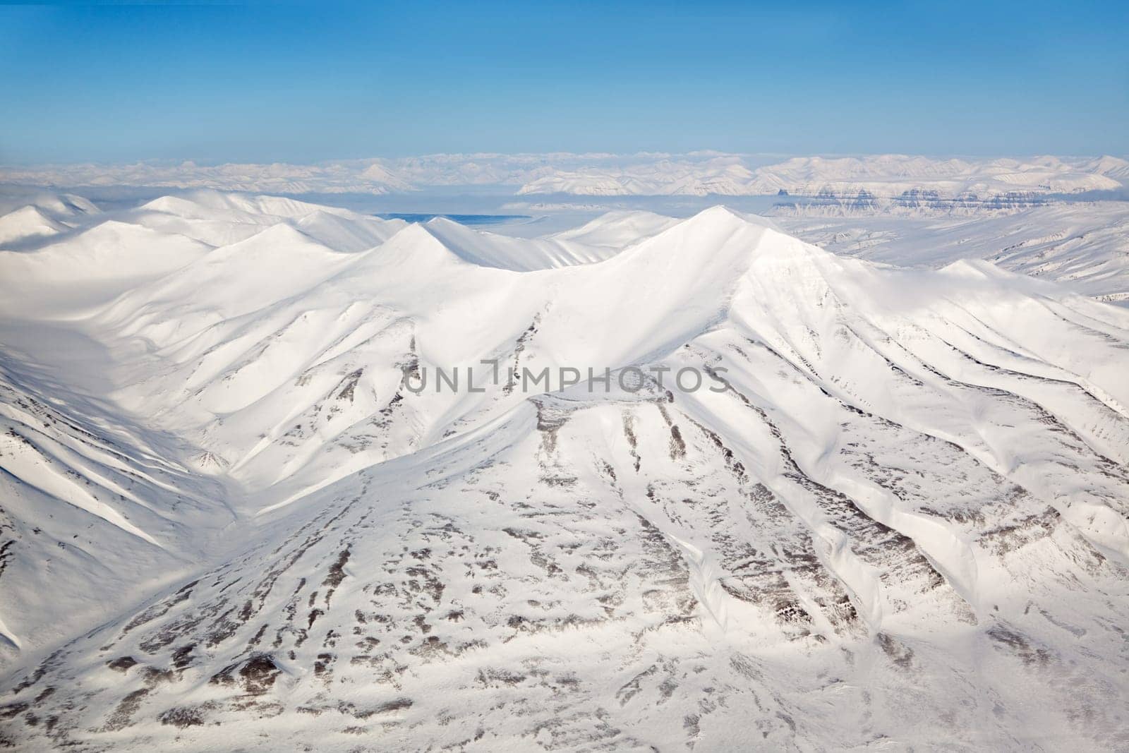 A snow covered mountain range in Svalbard