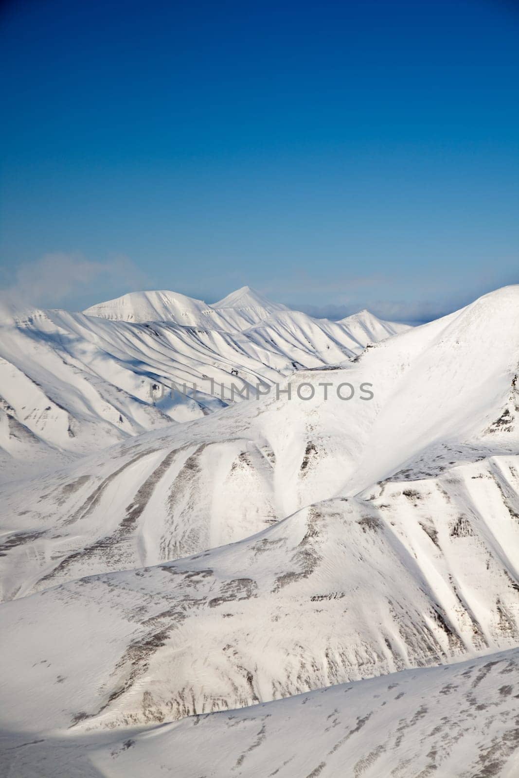 A snow covered mountain range in Svalbard