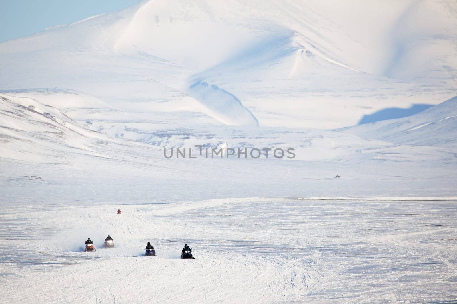 A group of snowmobiles on the ice outside Longyearbyen, Svalbard Norway