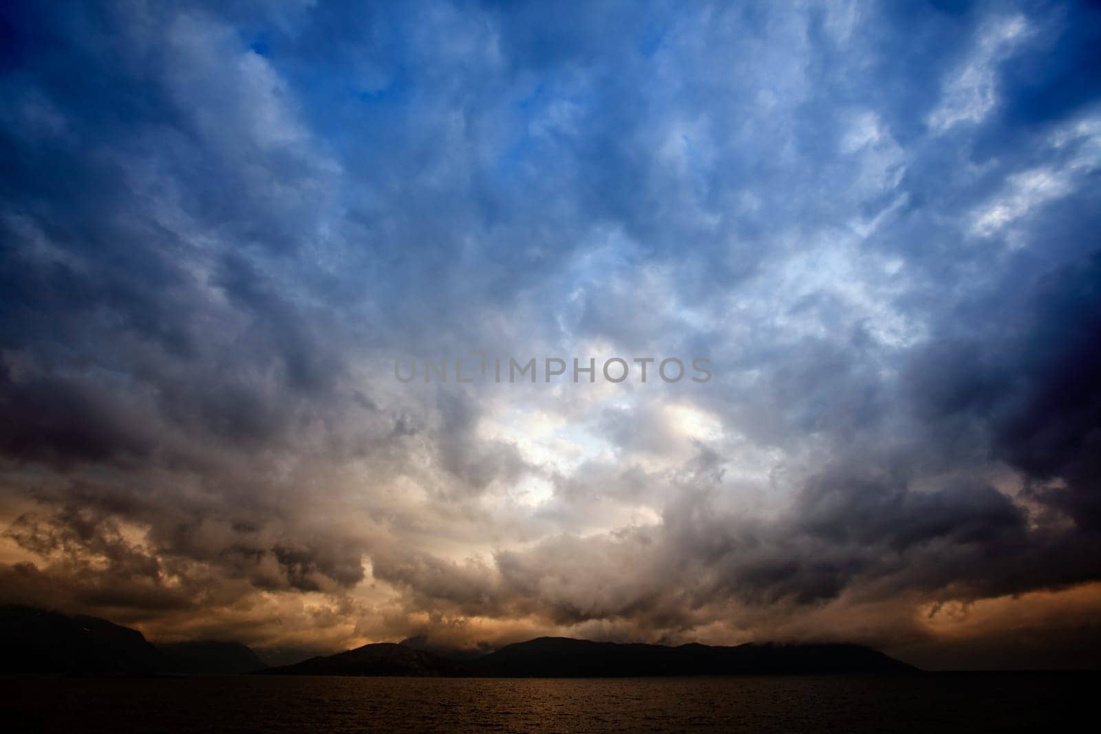 A brewing storm on an ocean sunset