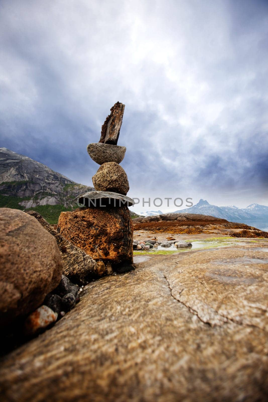 A rock stacking sculpture statue on a Norwegian landscape