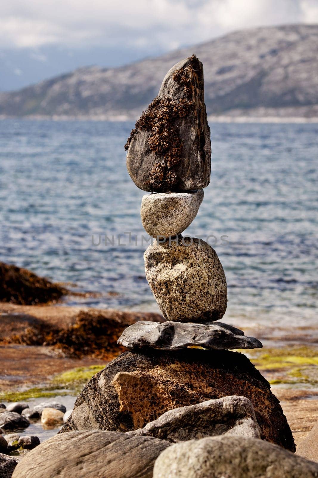 A rock stacking sculpture statue on a Norwegian landscape