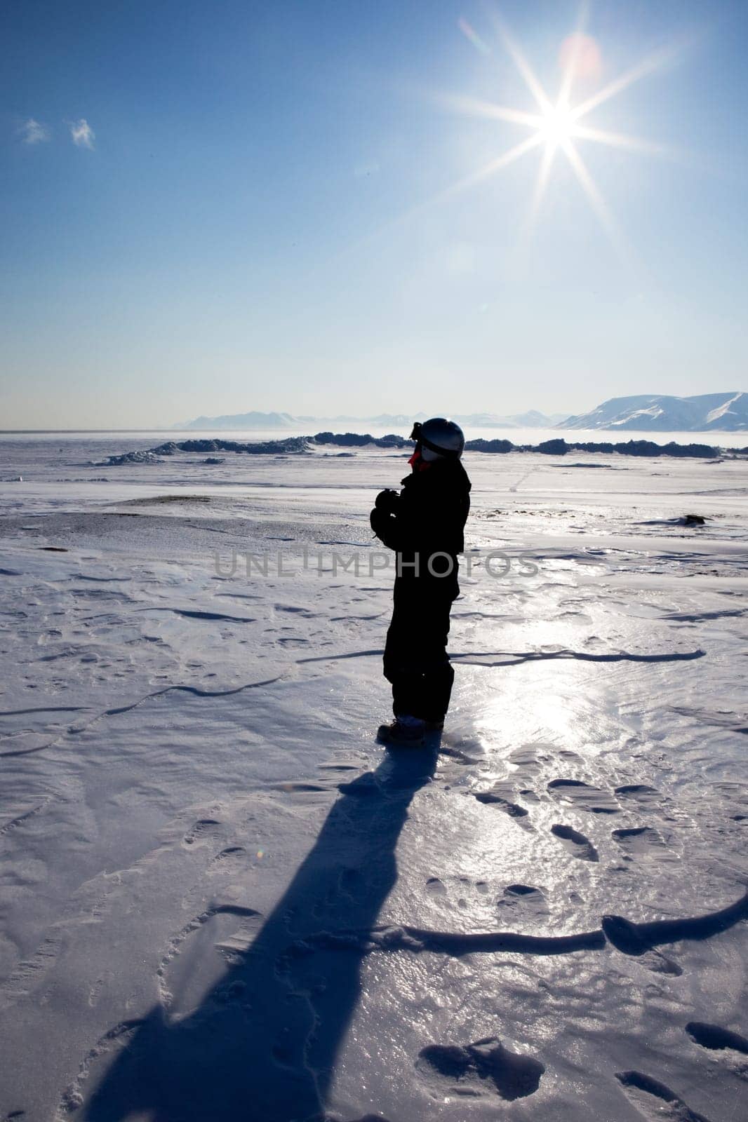 A tourist on a frozen ladscape, Spitsbergen, Svalbard, Norway