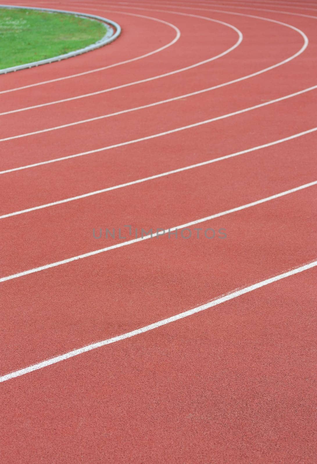 Athletics track with its lane, white lines and turn