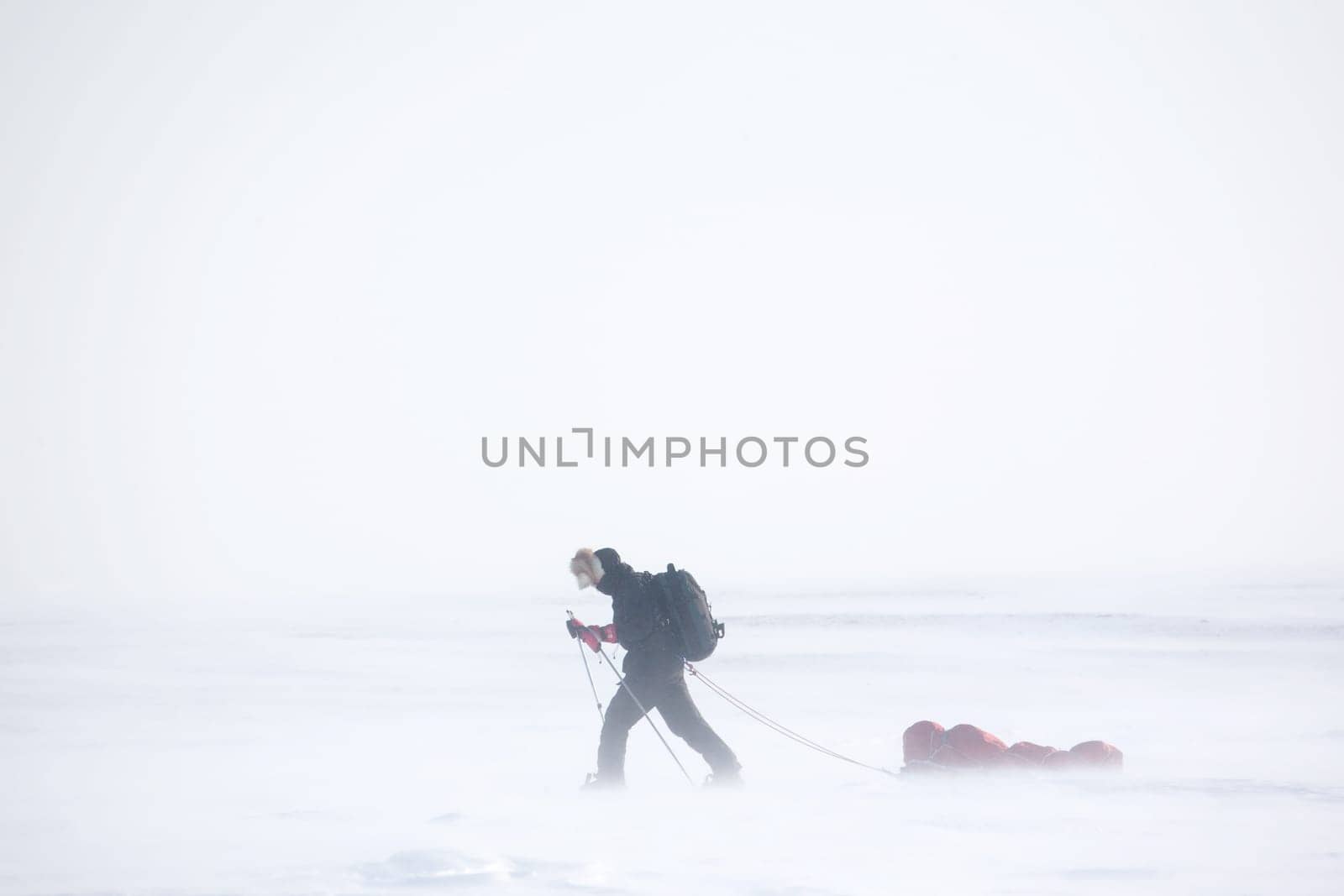 A single person on a winter expedition in a snow storm