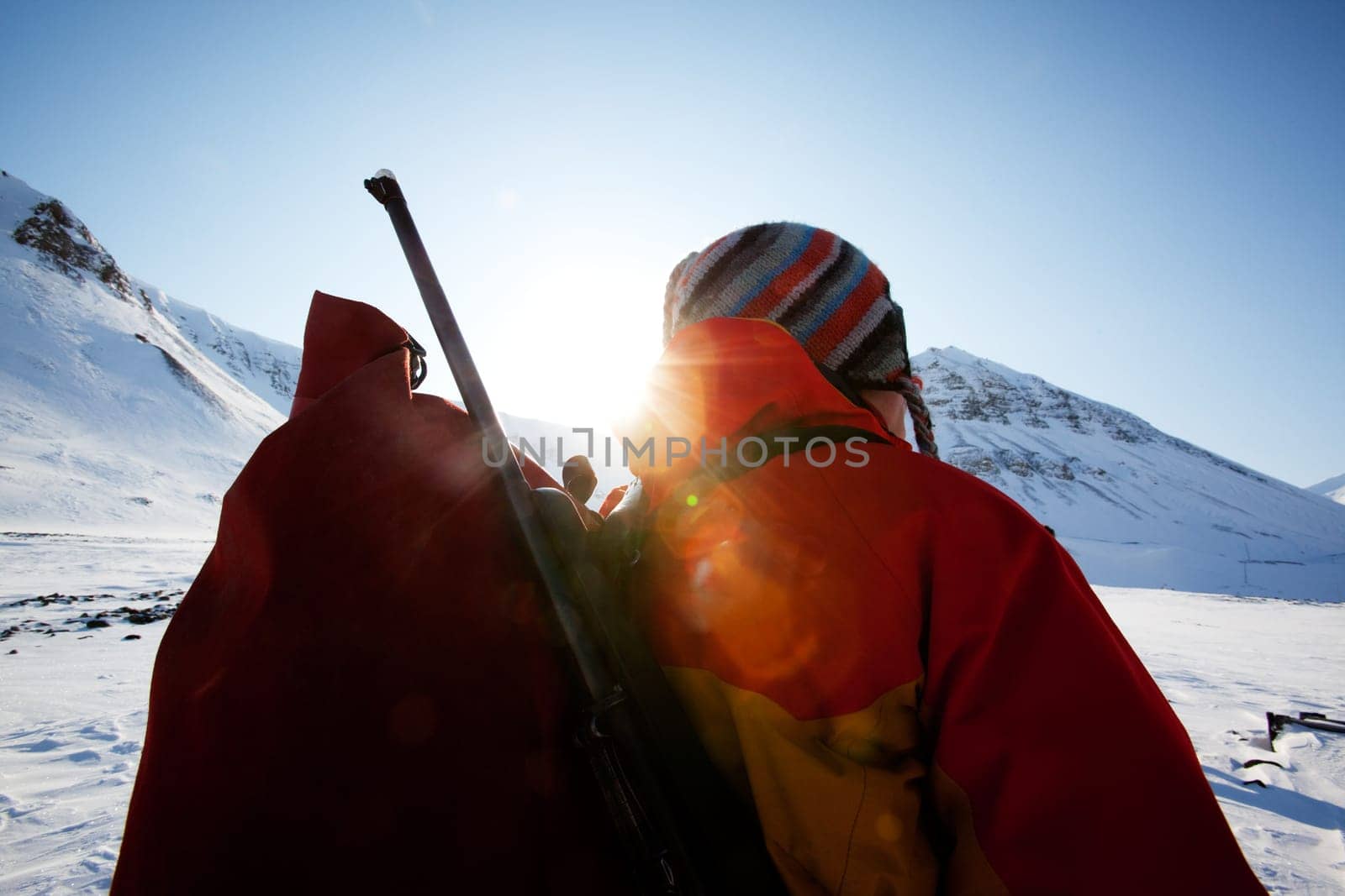 A portrait of a female adventurer against a mountain landscape