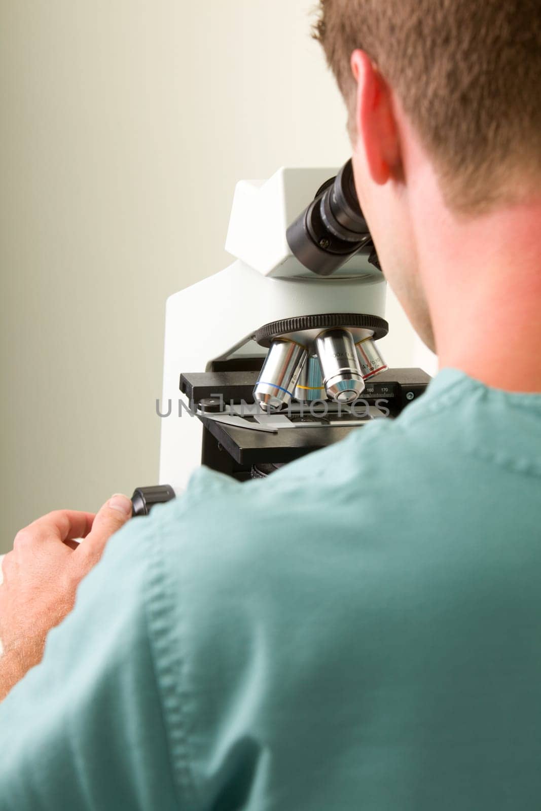 A man looking through a microscope