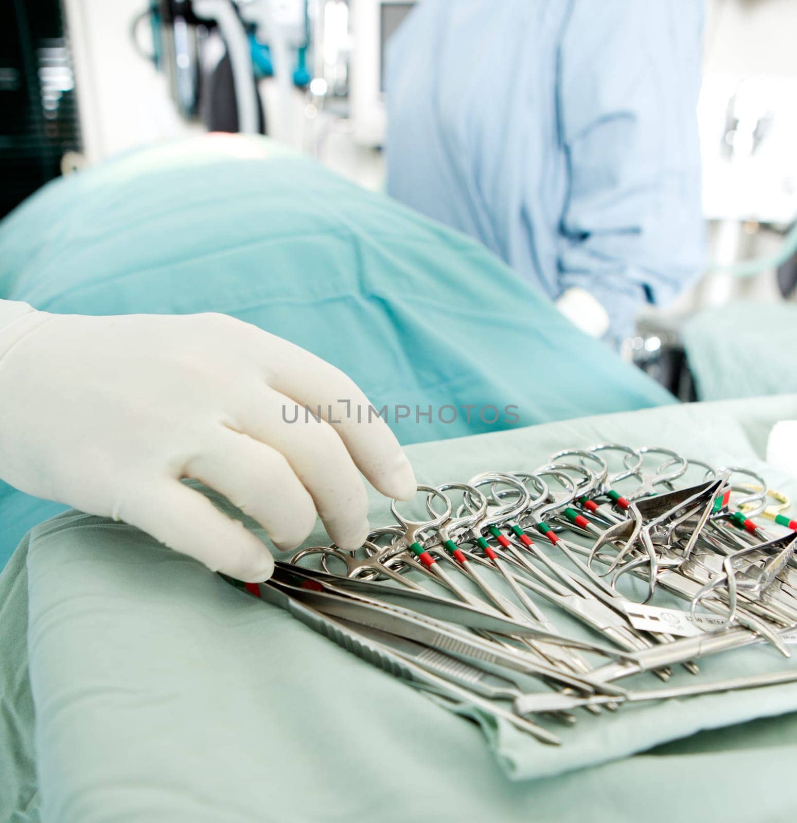 Detail shot of steralized surgery instruments with a hand grabbing a tool