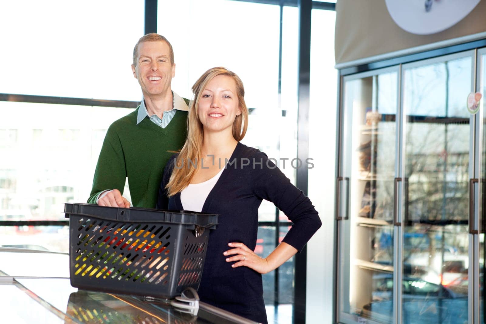 A portrait of a happy couple in a supermarket buying groceries