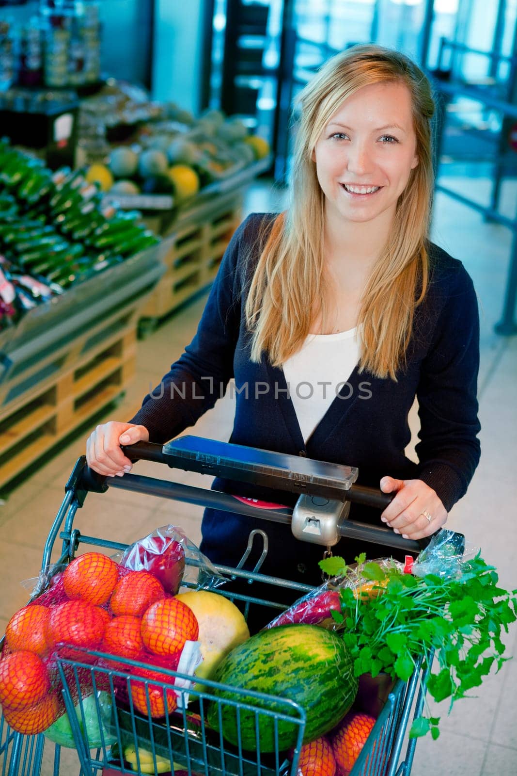 A portrait of a happy female shopper in a supermarket