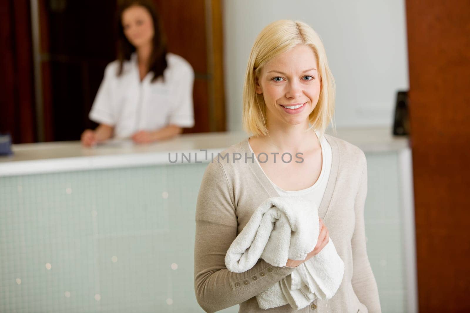 Portrait of a happy spa customer smiling and looking at the camera