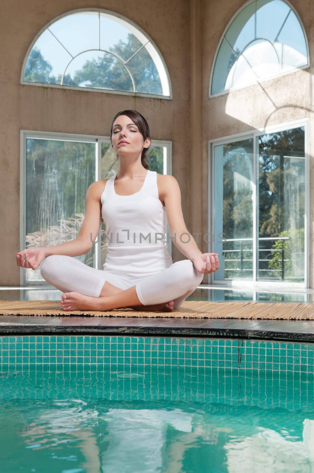 Young woman meditating sitting in lotus position