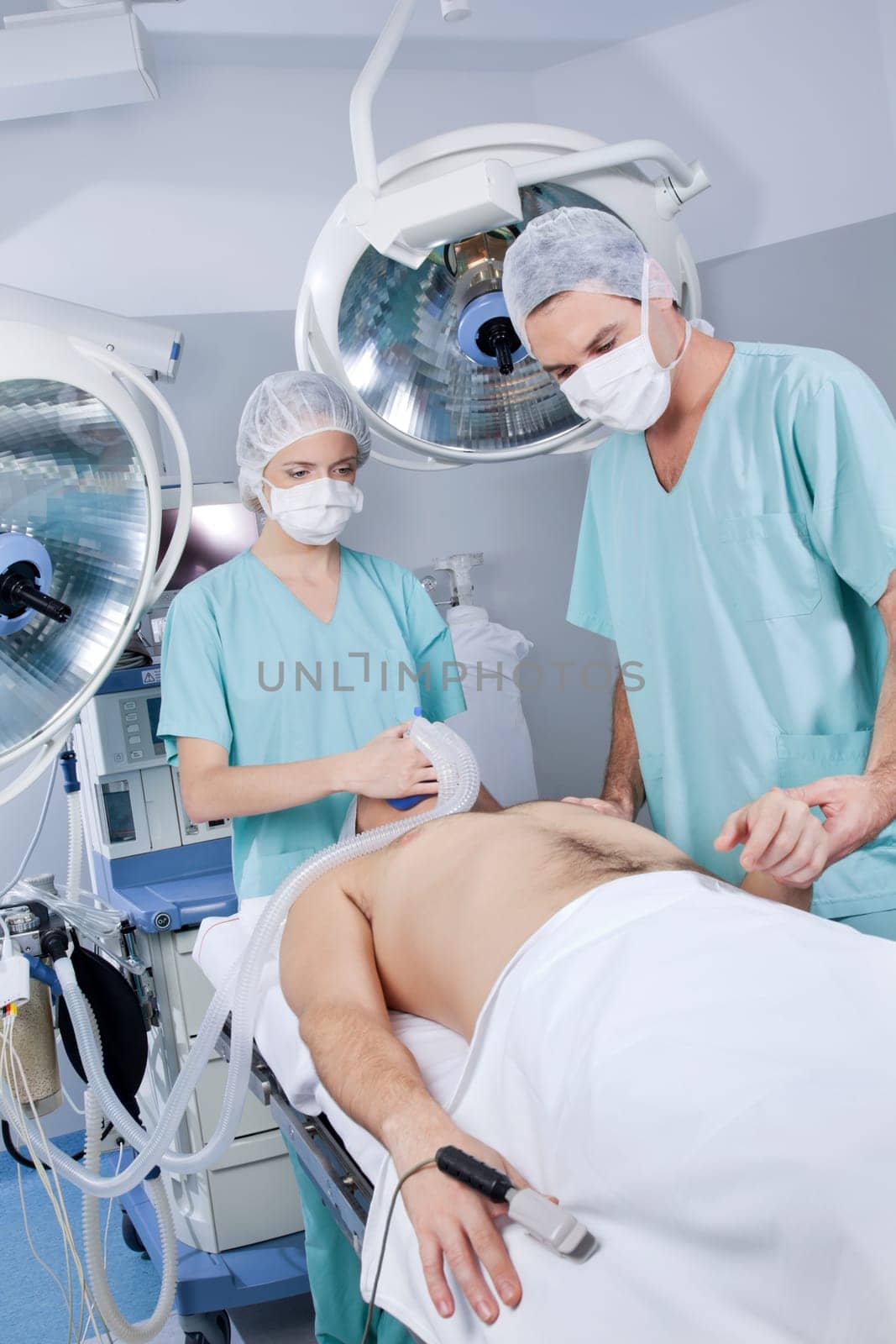 Nurse and doctor preparing the patient for an operation in a hospital