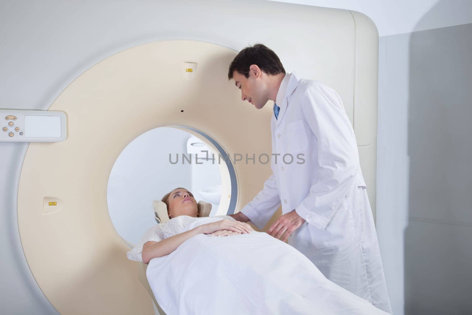 Doctor examining patient before CT scan