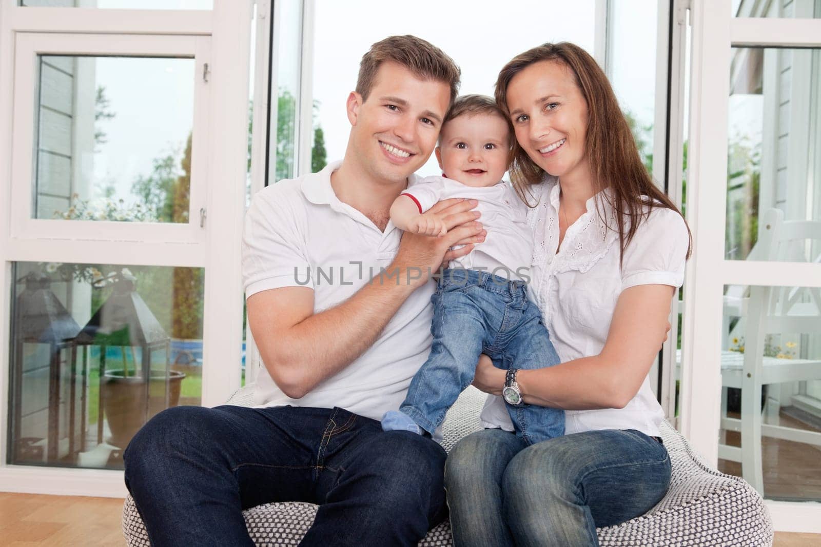 Portrait of happy family sitting on couch at home