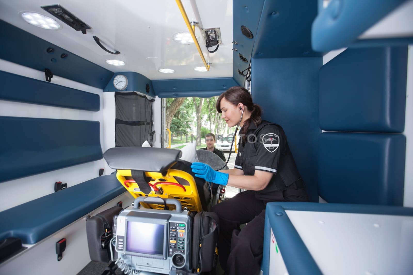 EMT worker listening to heart rate of patient