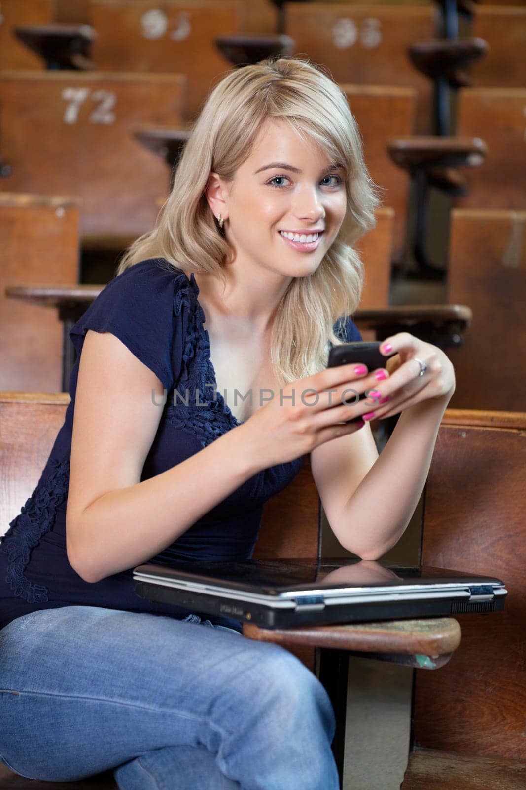 Portrait of young college girl using cell phone