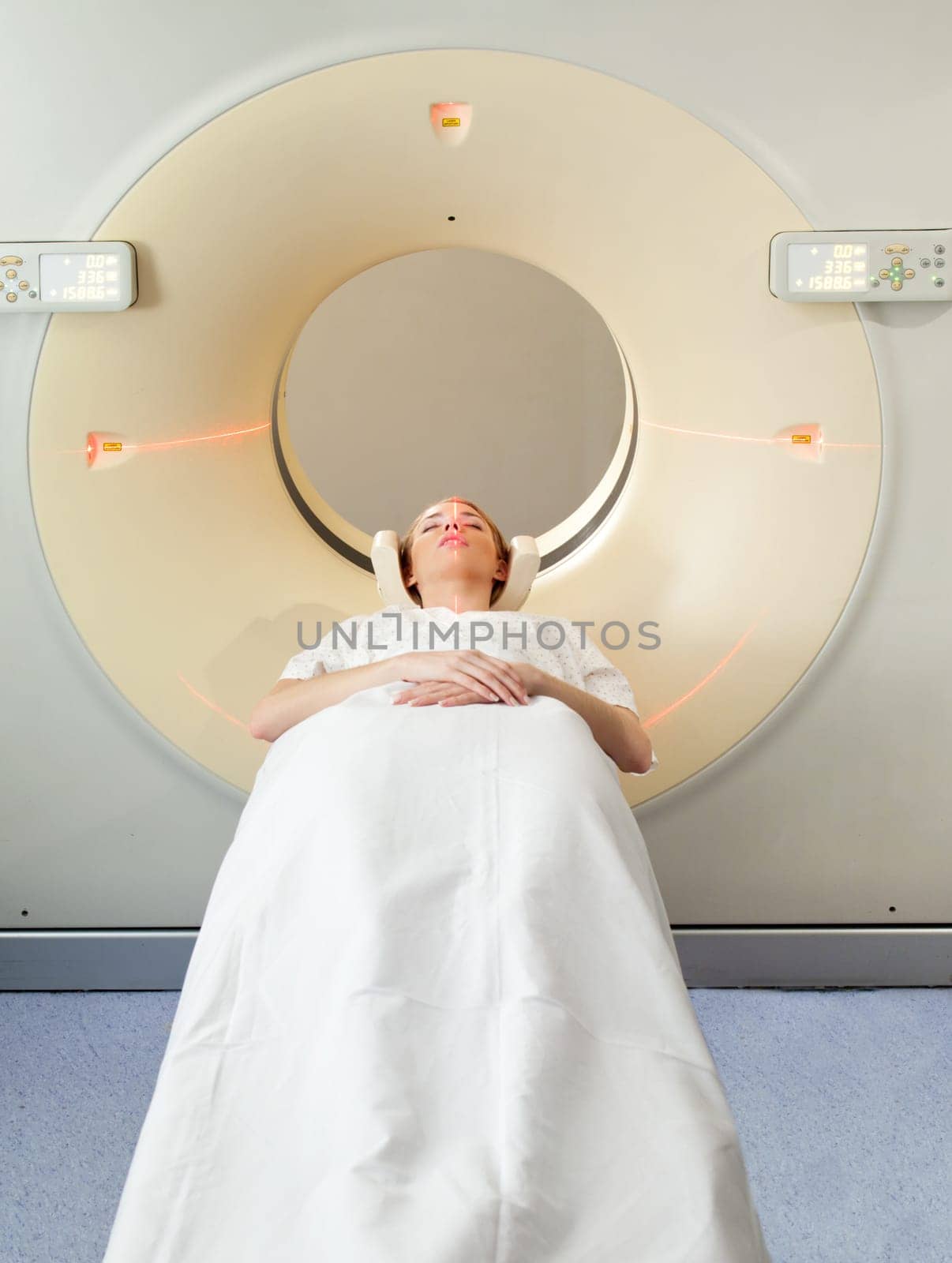 A young woman undergoing a CT scan in a hospital