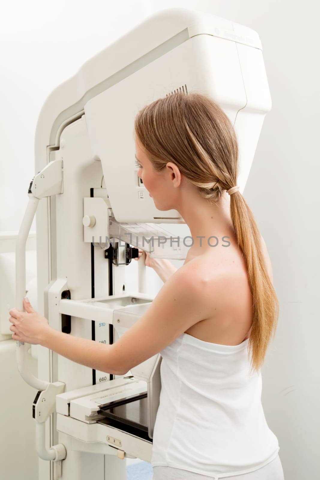 A woman taking a Mammogram test in a hospital