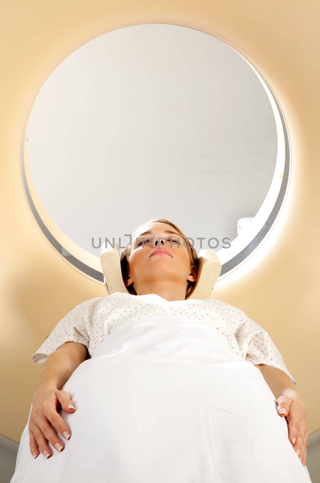 A young woman taking a CT scan - screening test