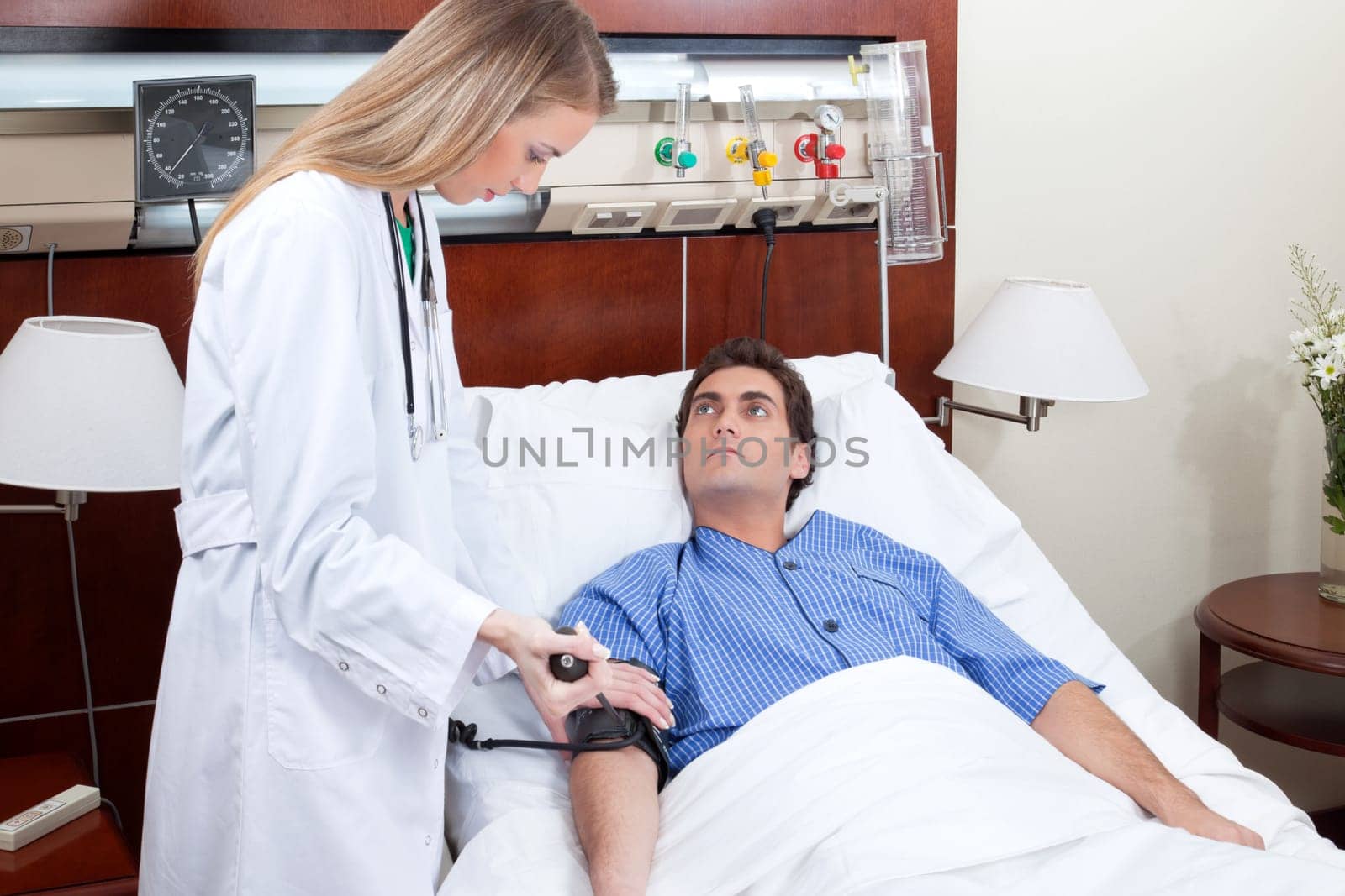 Doctor checking the blood pressure of the patient in hospital