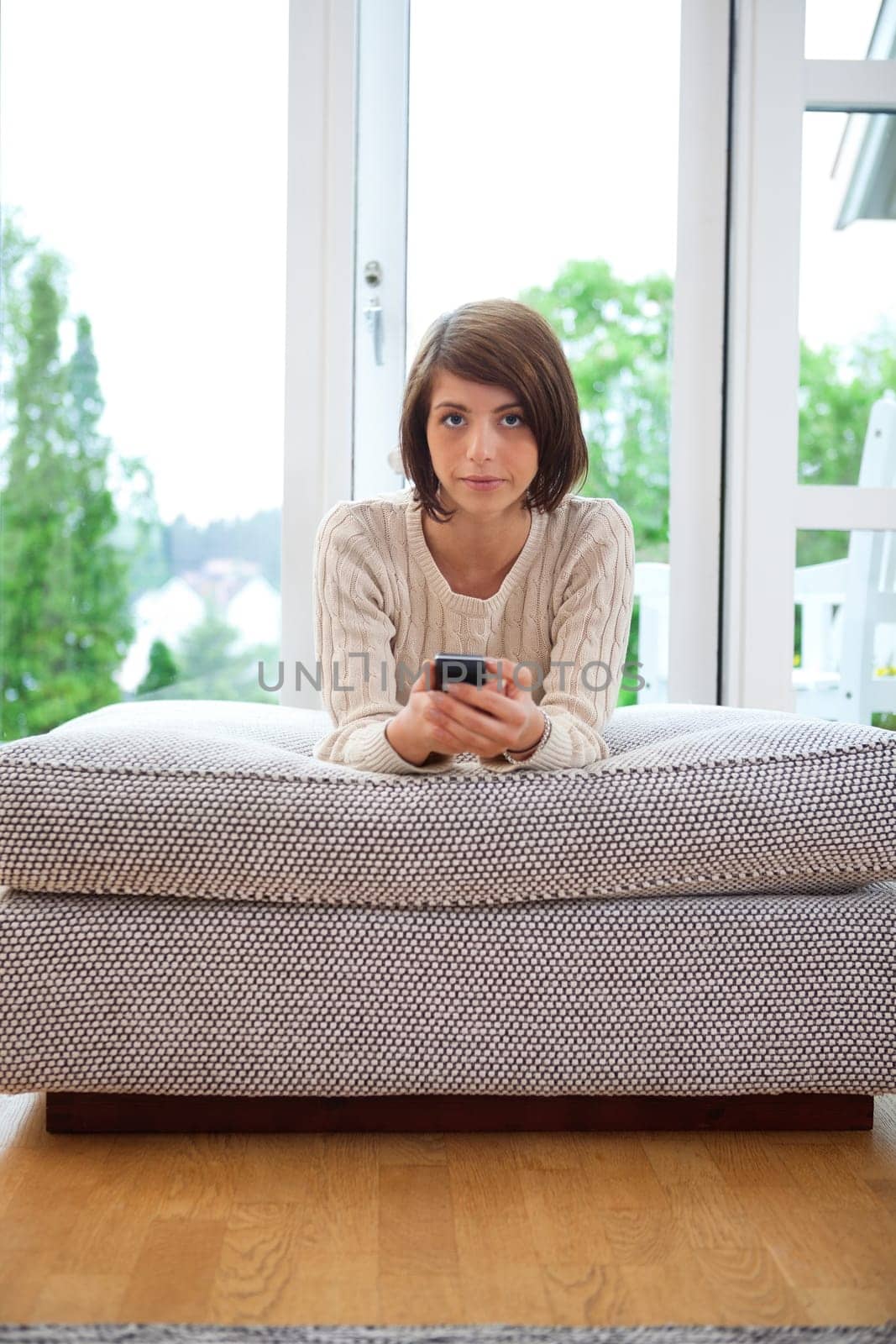 Portrait of a serious looking female holding cell phone
