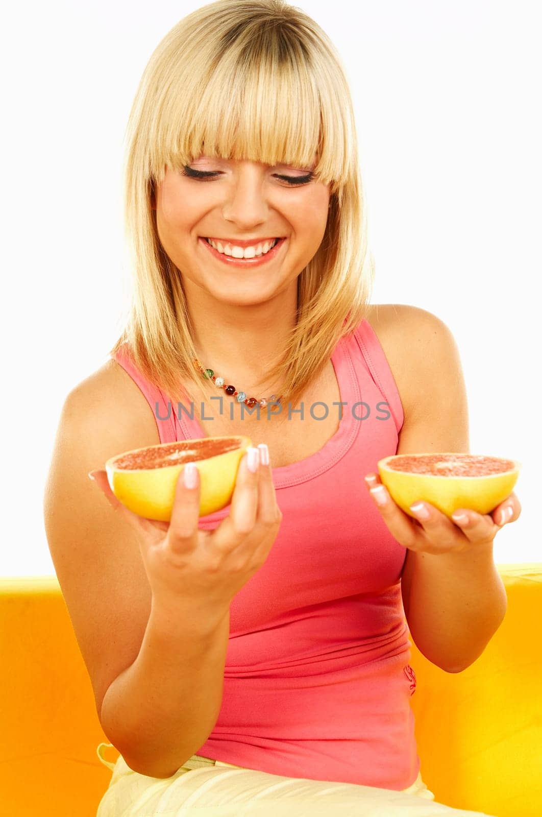Happy beautiful women with holding grapefruit