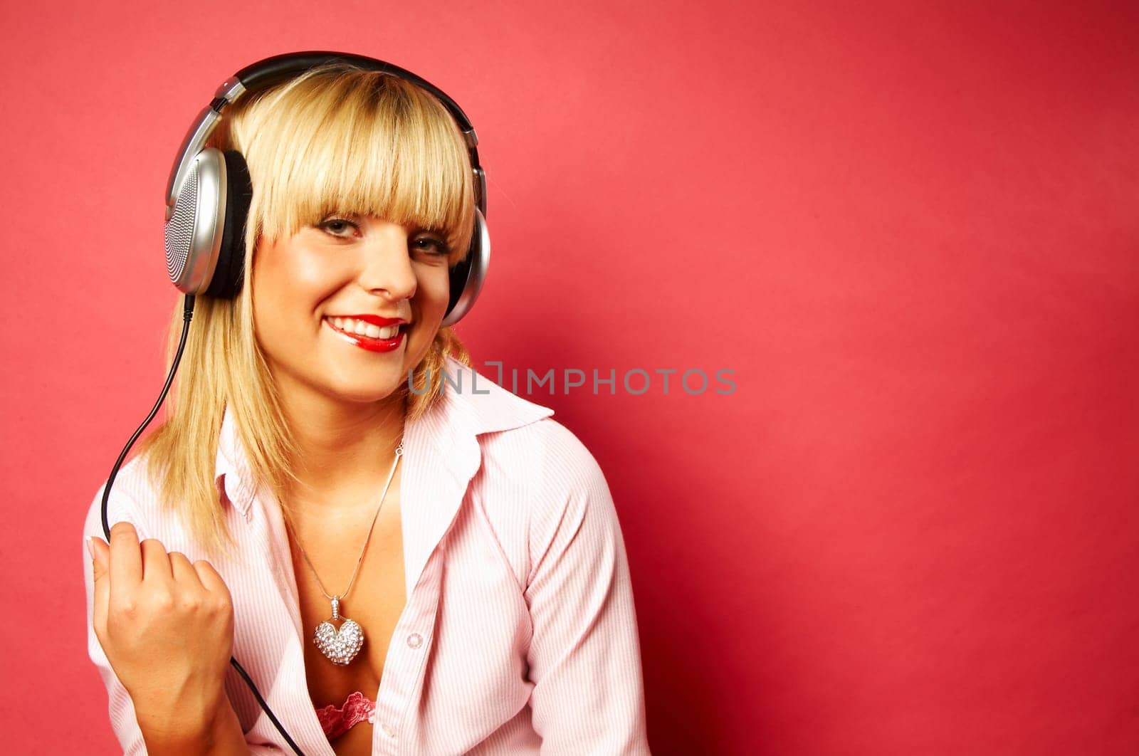 Young beautiful happy women listening music in headphones