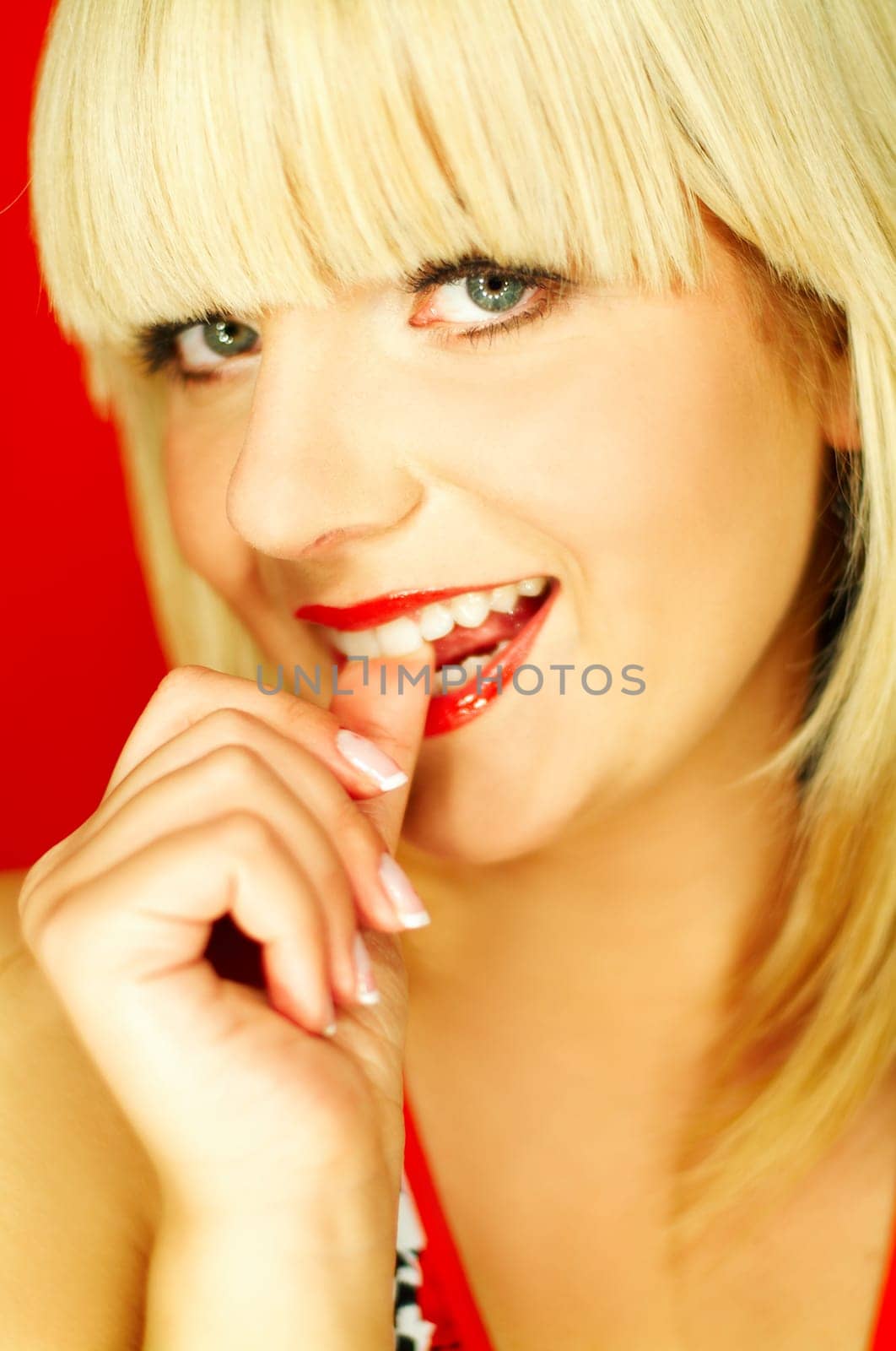 Portrait of beautiful young smiling woman with red lipstick