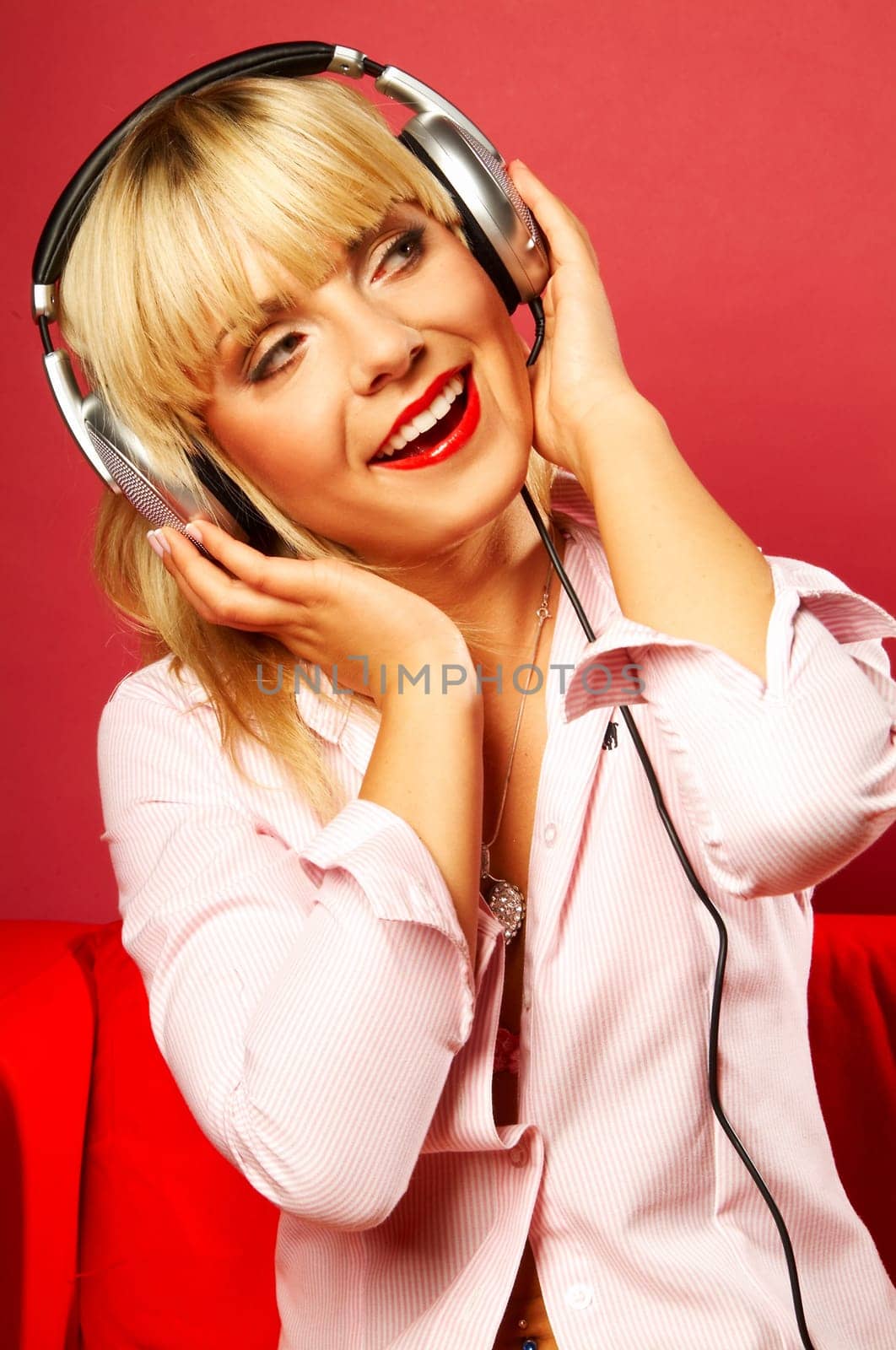 Young beautiful happy women listening music in headphones