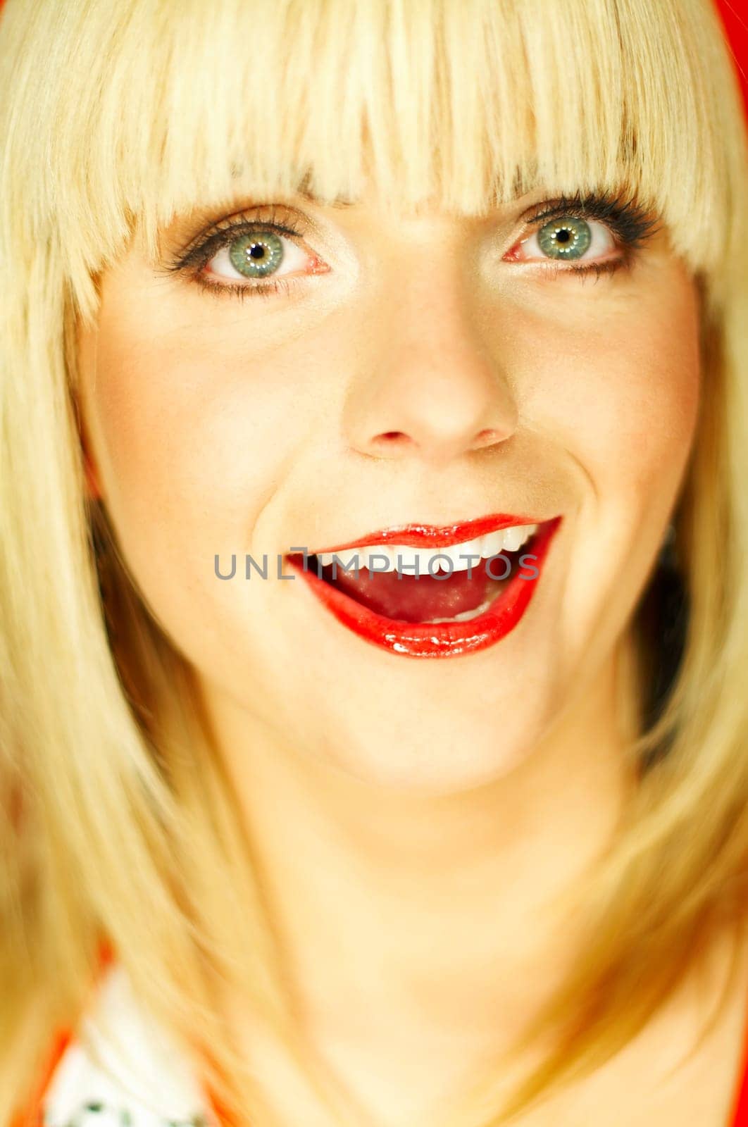 Portrait of beautiful young smiling woman with red lipstick
