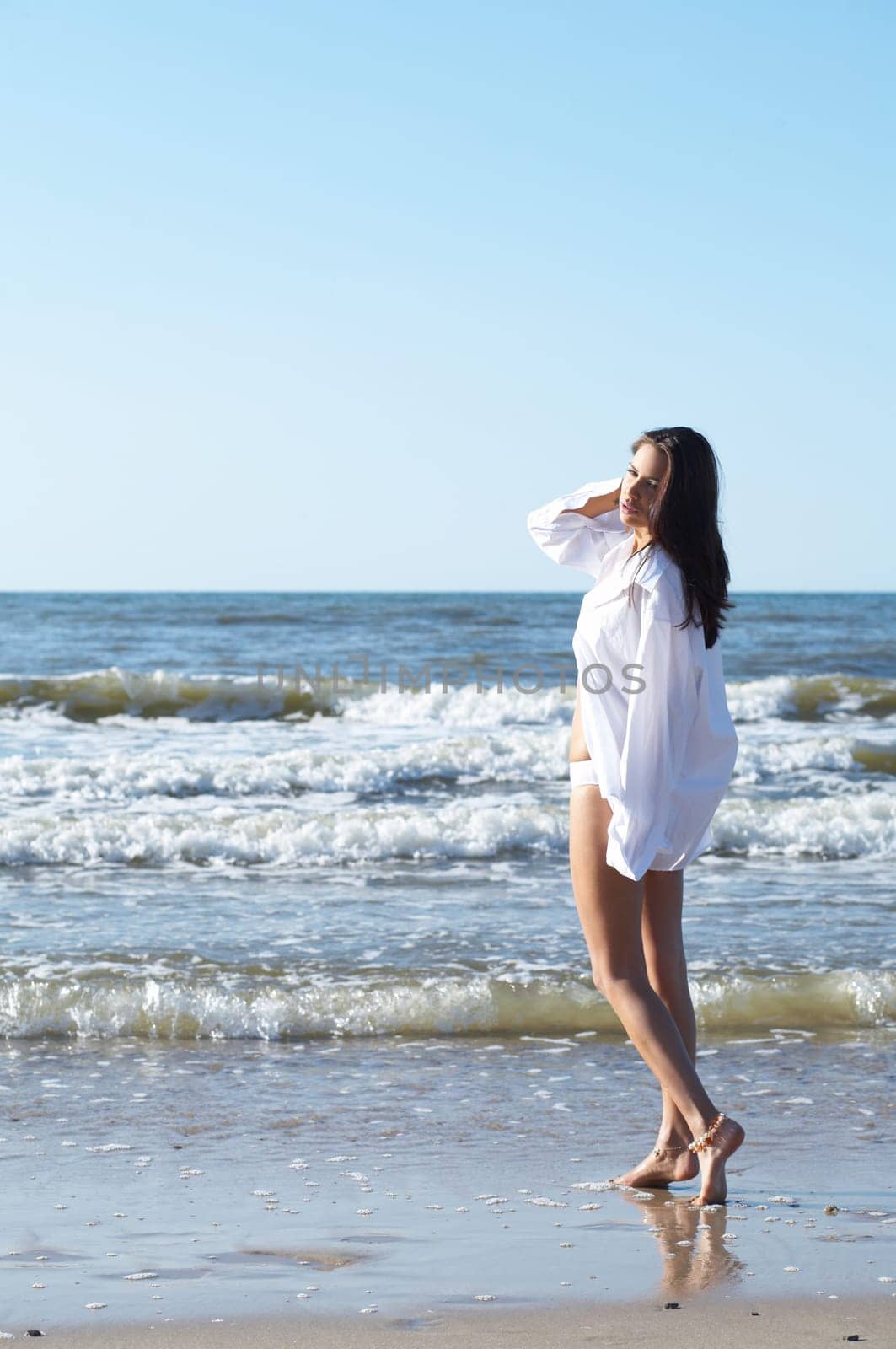 20-25 years old Beautiful Woman on the beach, wearing shirt