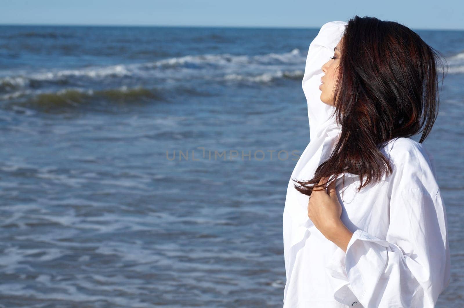20-25 years old Beautiful Woman on the beach, wearing shirt