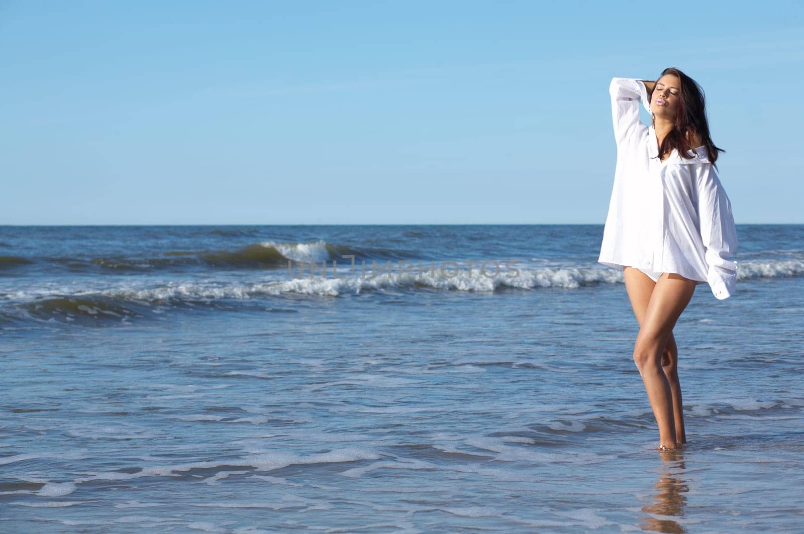 20-25 years old Beautiful Woman on the beach, wearing shirt