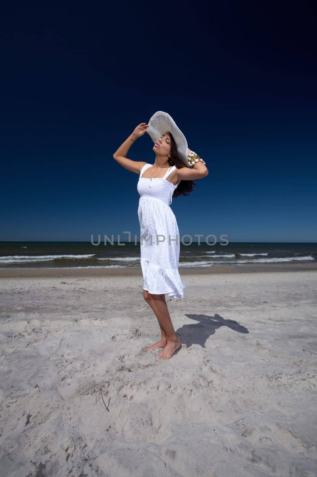 20-25 years old Beautiful Woman on the beach, wearing hat