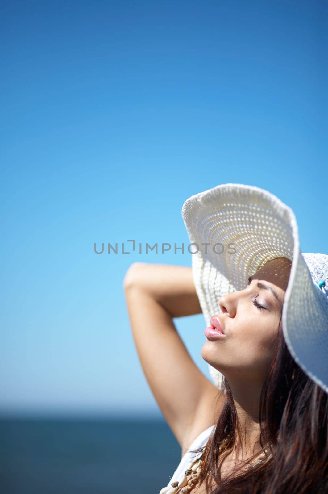 20-25 years old Beautiful Woman on the beach, wearing hat
