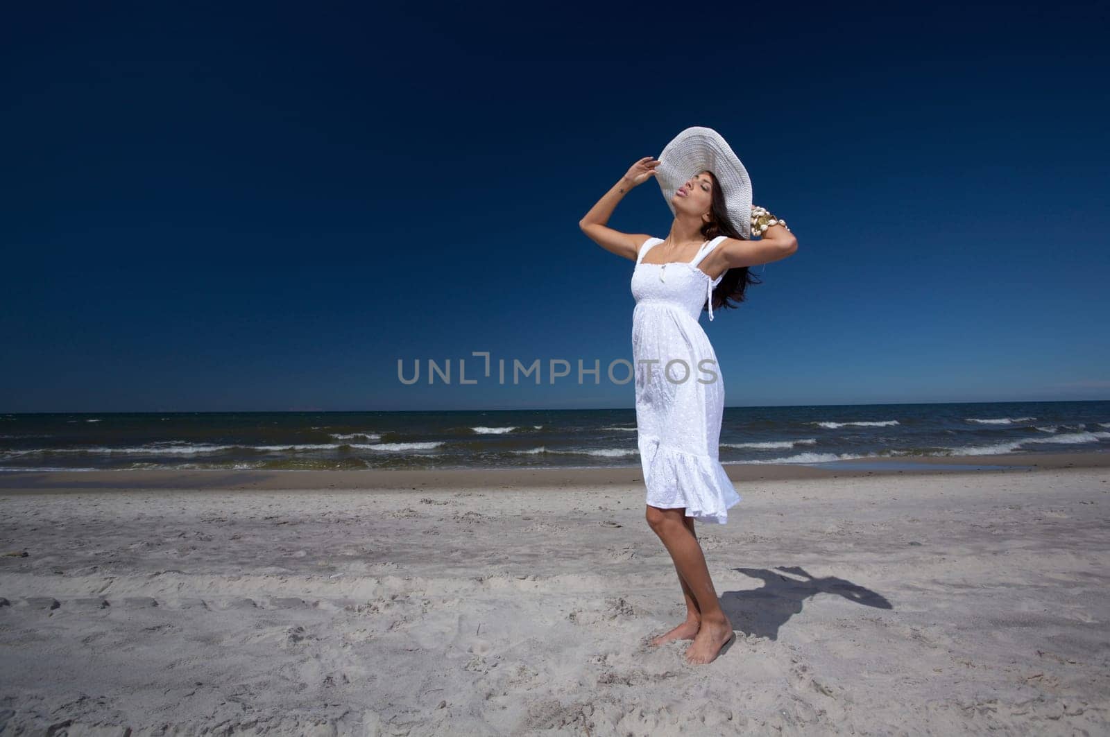 20-25 years old Beautiful Woman on the beach, wearing hat