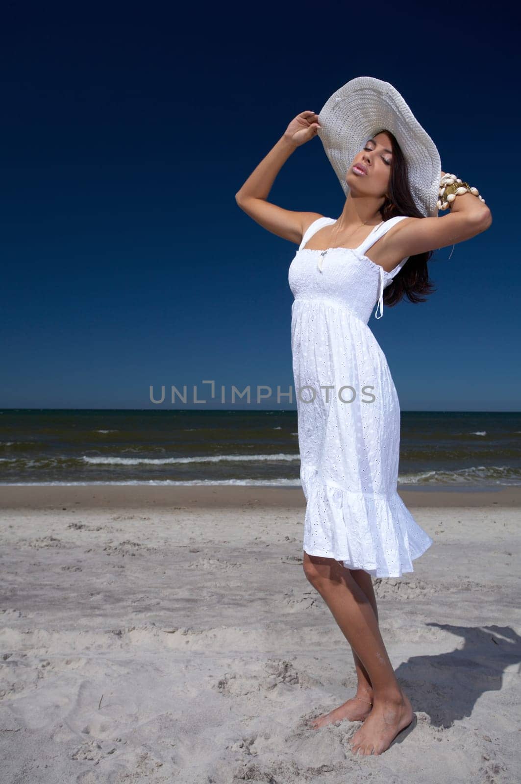20-25 years old Beautiful Woman on the beach, wearing hat