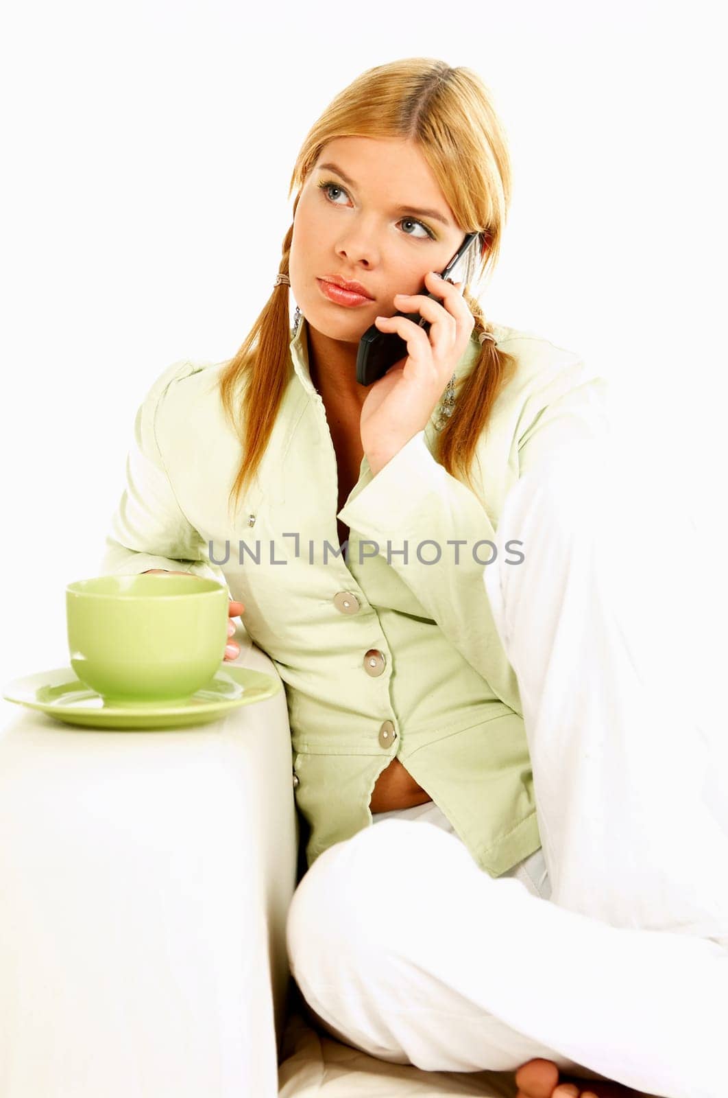 Portrait of attractive beautiful young woman with green cup of black coffee and cell phone