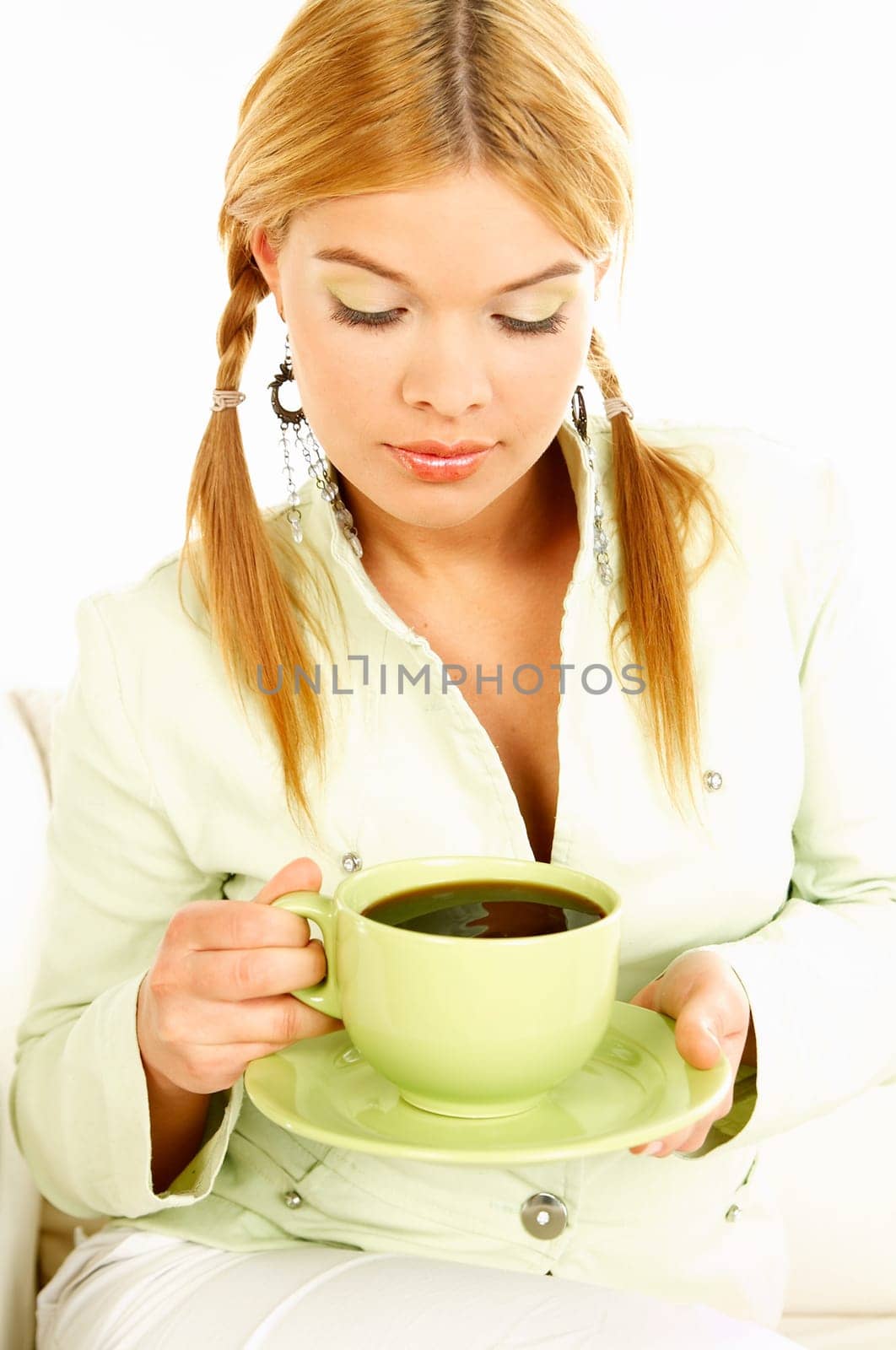 Portrait of attractive beautiful young woman with green cup od black coffee